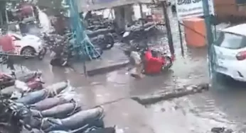 WATCH: Cop and his wife suddenly vanish underwater as their scooter runs into open drain on road in UP’s Aligarh