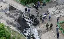 Law enforcement officers work at the site of a car explosion, which killed senior Russian military officer in Balashikha